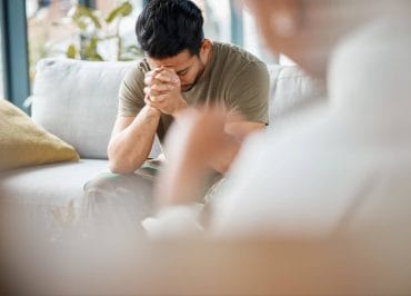 Person in psychological distress being comforted by a professional.
