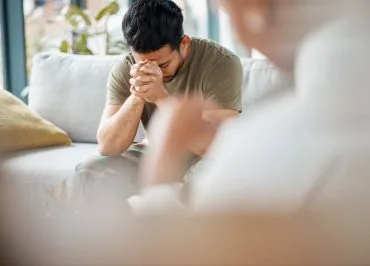 Person in psychological distress being comforted by a professional.